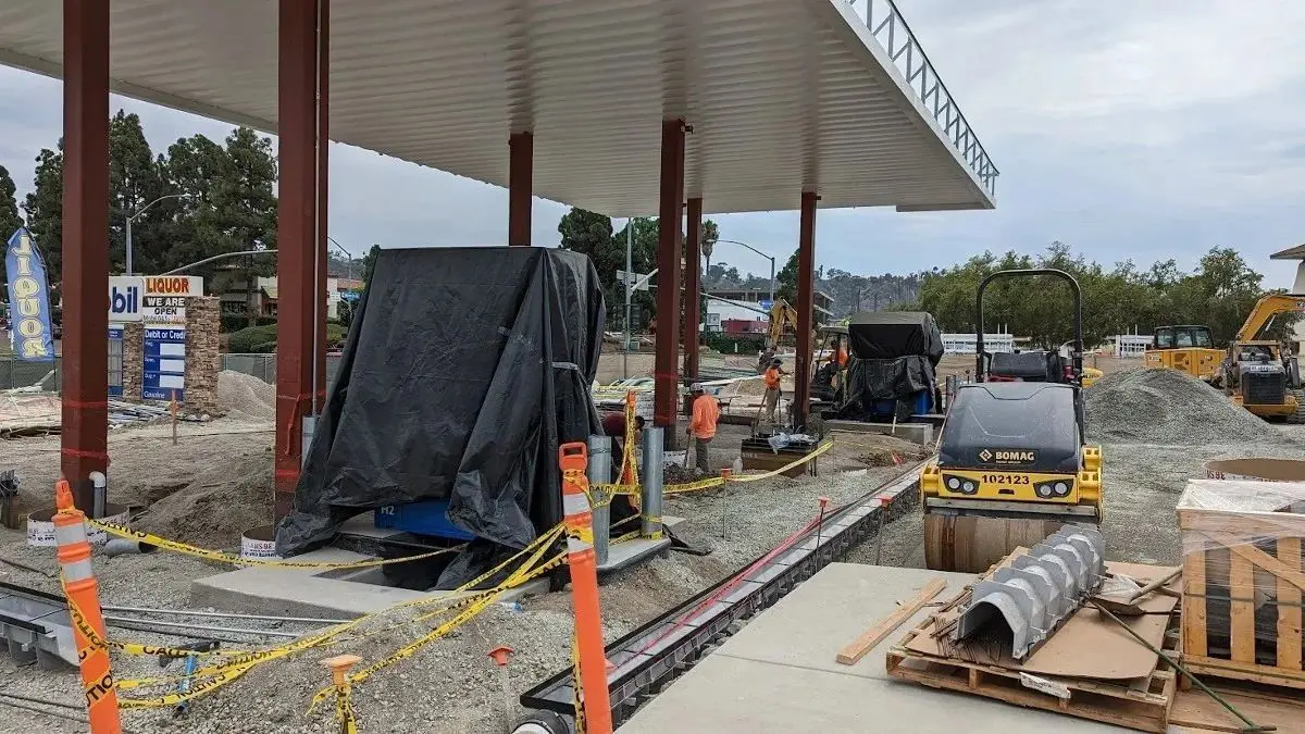 Gas station under construction with equipment.