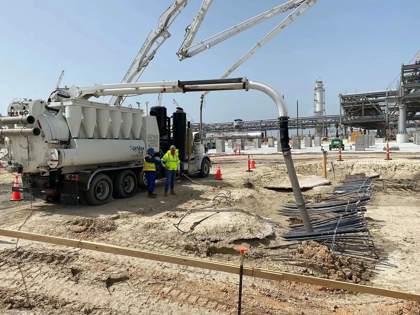 Construction site with industrial vacuum truck.