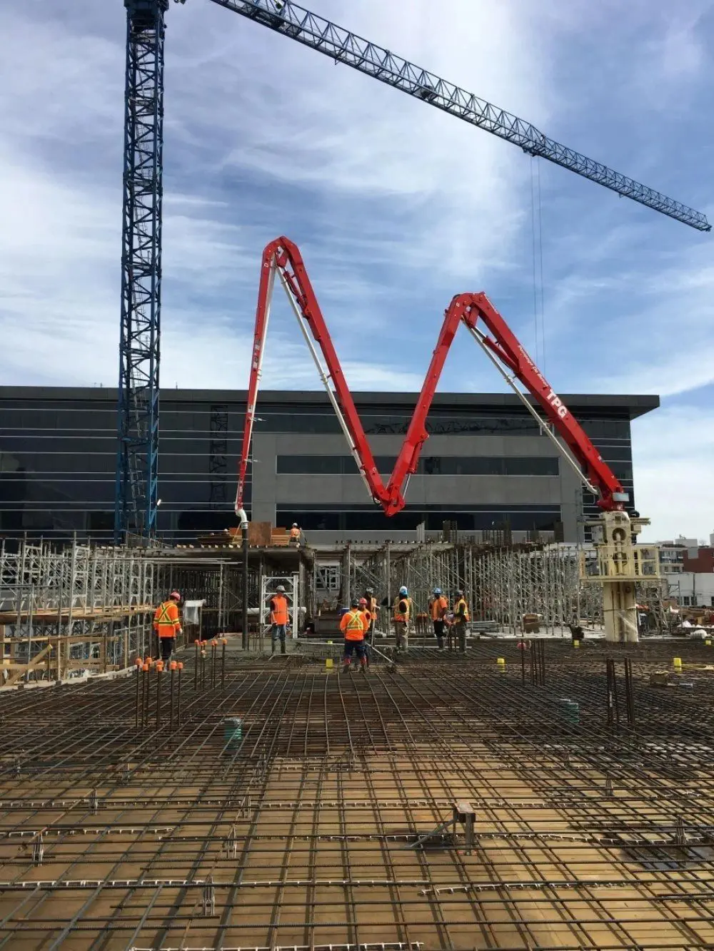 Construction site with cranes and workers.